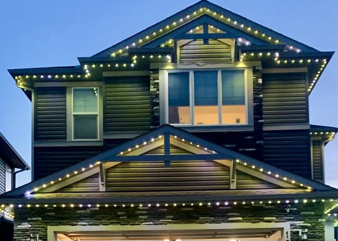 Craftsman home with warm roofline lighting